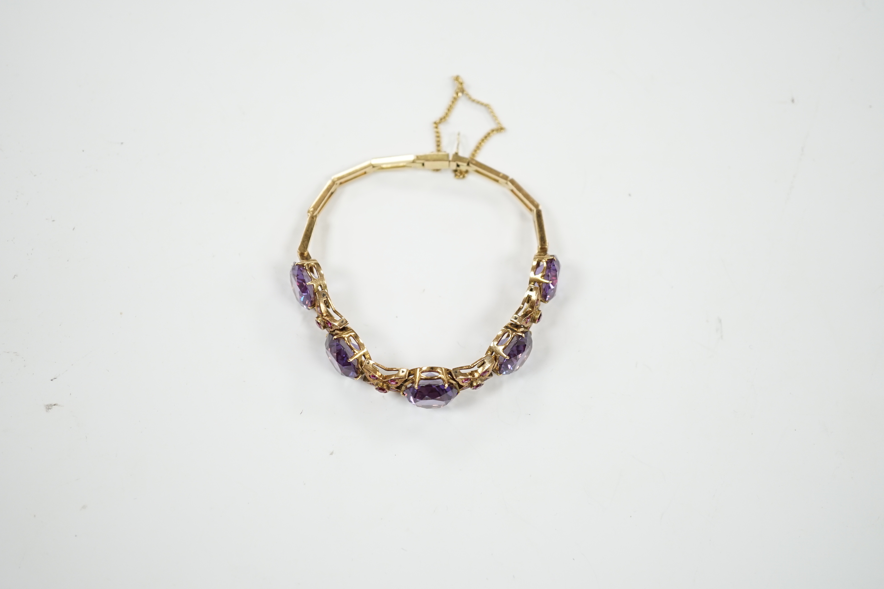 A yellow metal, synthetic colour change corundum and gem set bracelet. approx. 18cm, gross weight 22.7 grams.